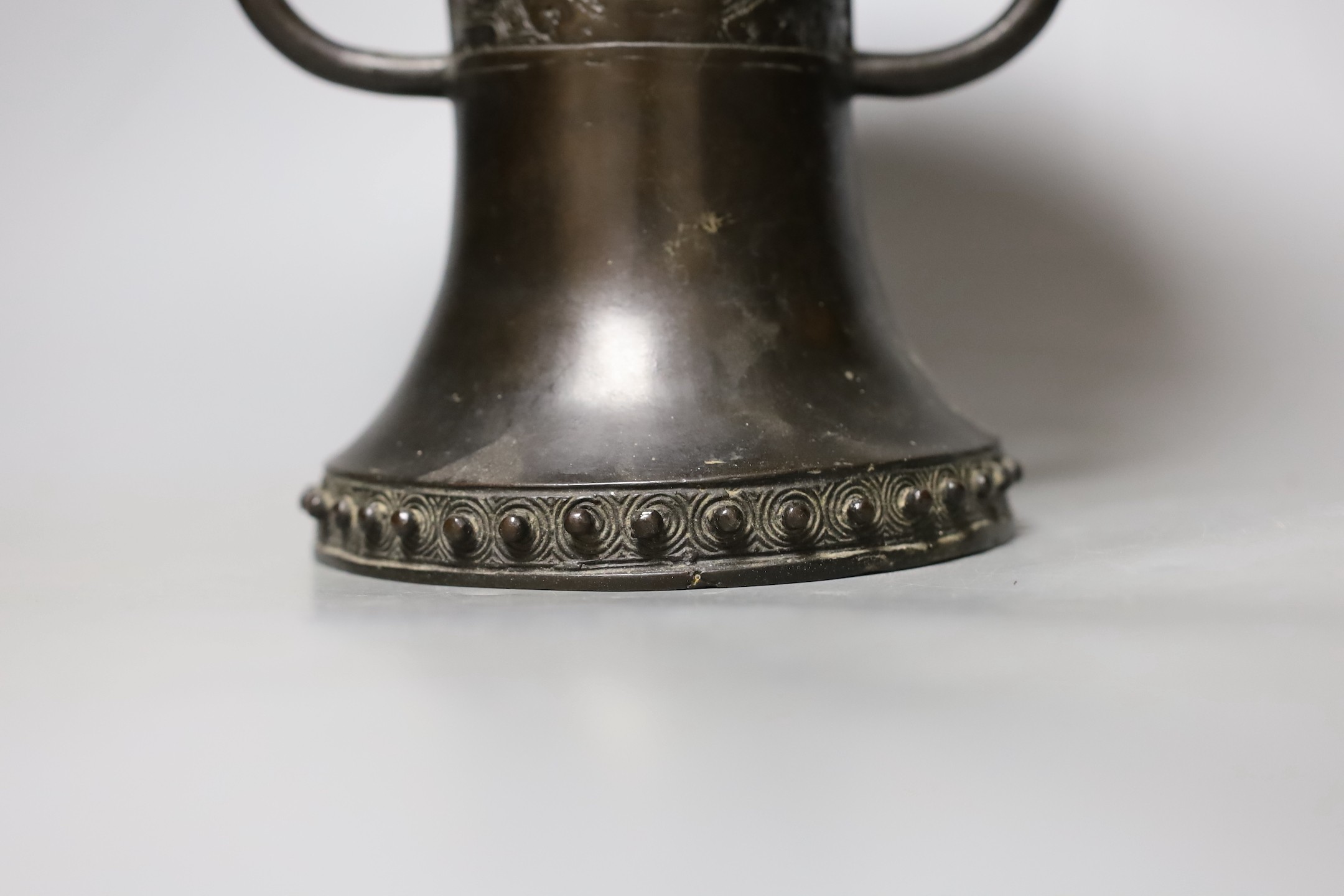 A Chinese or Japanese archaistic bronze two handle vase, 19th century, 24 cms high.